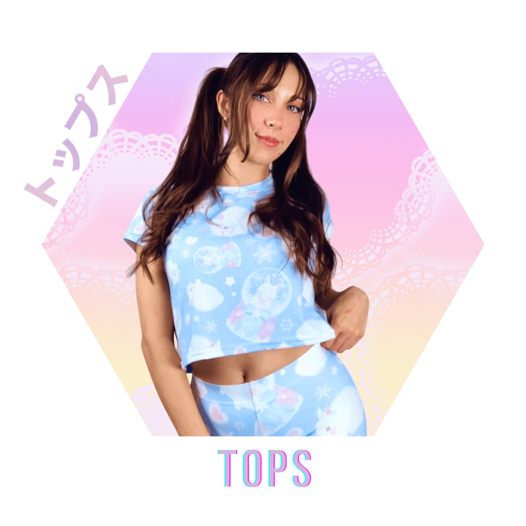 Model wearing a blue graphic crop top with celestial designs, perfect for trendy fashion lovers.