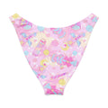 Indica Magica V-cut bikini bottom with colorful, playful print on soft pink background, perfect for fun sunny days.