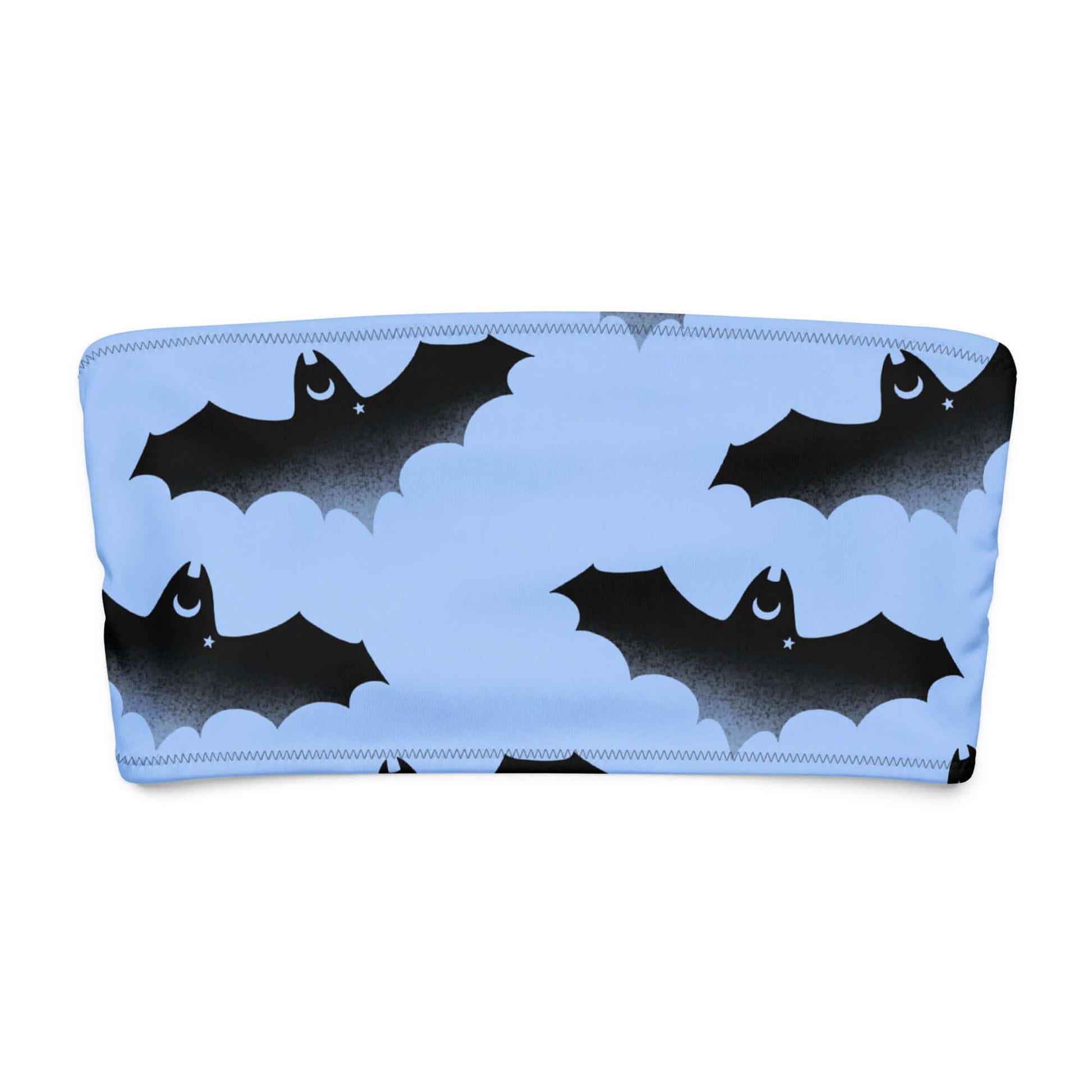 Lilith bandeau bikini top with playful bat and moon pattern on a blue background.