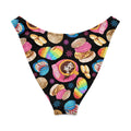 V-cut bikini bottom featuring a colorful dessert print with cookies, donuts, and a cup of hot cocoa on a black background.