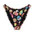 Colorful Pan Dulce V-cut bikini bottom with festive dessert patterns on a black background.