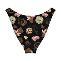 Royal Cookie V-cut bikini bottom with playful dessert design featuring crowns, chocolates, and sweets on a black background.