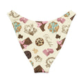 Royal Cookie V-cut bikini bottom featuring a whimsical pattern of chocolates and crowns in soft colors.